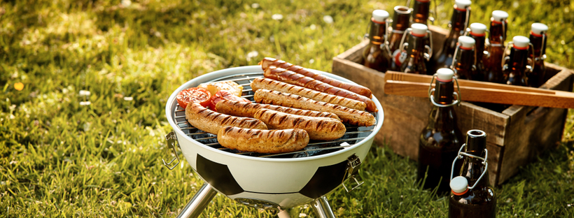 Sausages on a grill, beer bottles in a crate