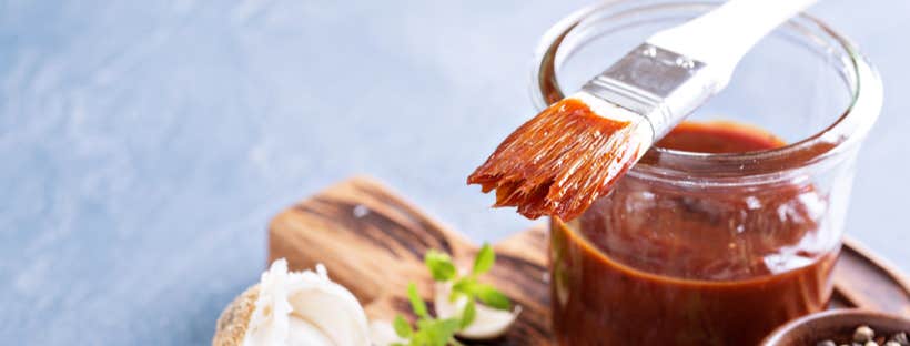 Sauce basting brush on top of a glass jar